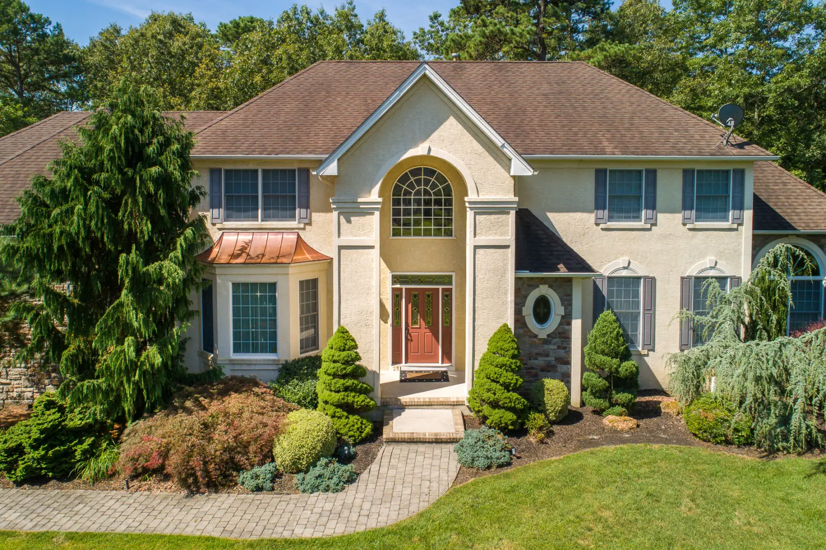 Two-story suburban house with manicured landscaping